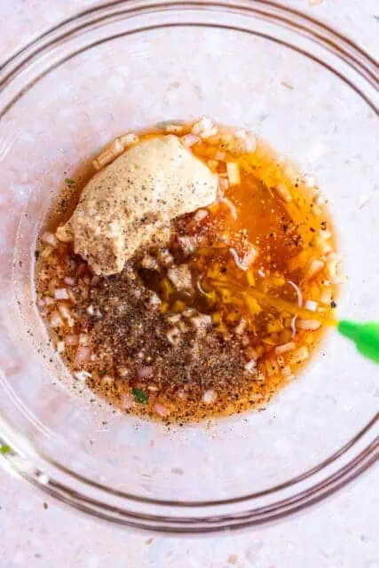mixing together a vinaigrette for a spring salad