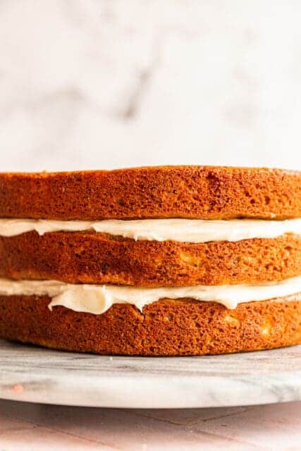 layers of hummingbird cake with cream cheese frosting in the middle
