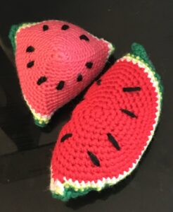 Crochet watermelon slices, colorful and soft, perfect for kids or as decorative accessories.