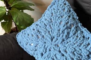 Soft blue textured throw blanket with chunky knit design.