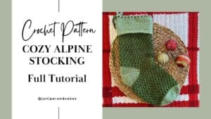 Handmade cozy alpine stocking with green and red yarns, perfect for holiday decor.