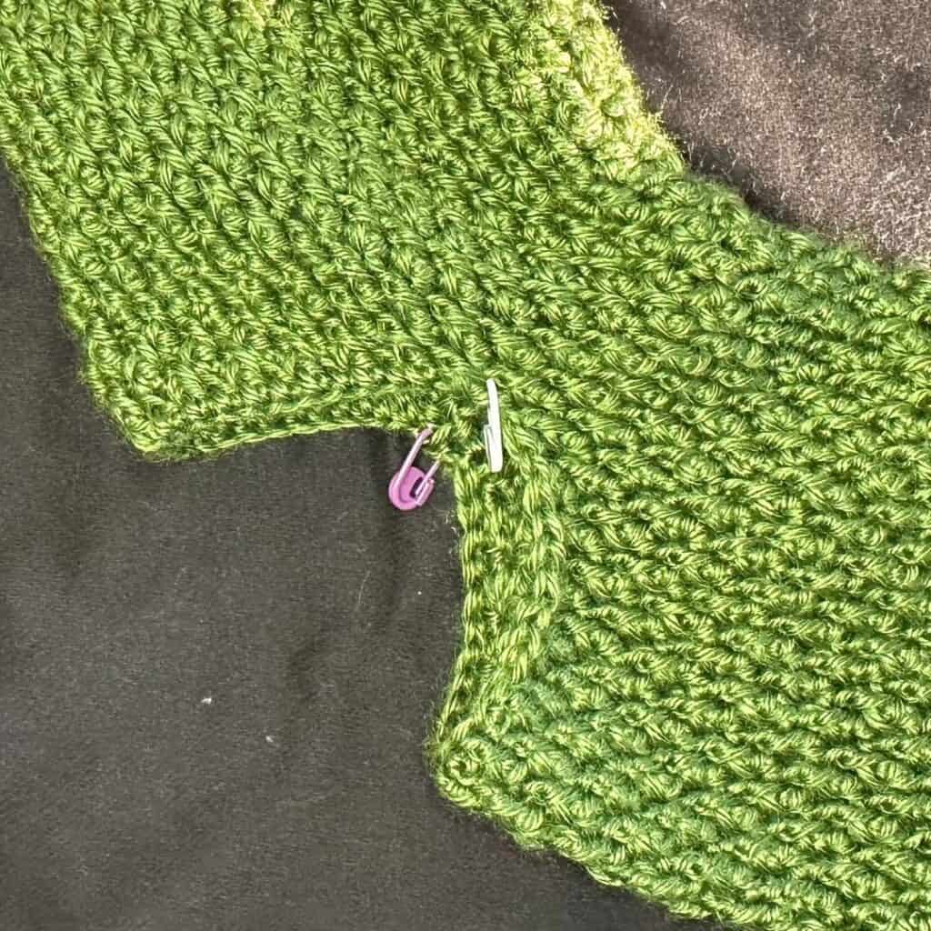 Crochet alpine stocking in vibrant green yarn, perfect for cozy winter decor and holiday stockings.