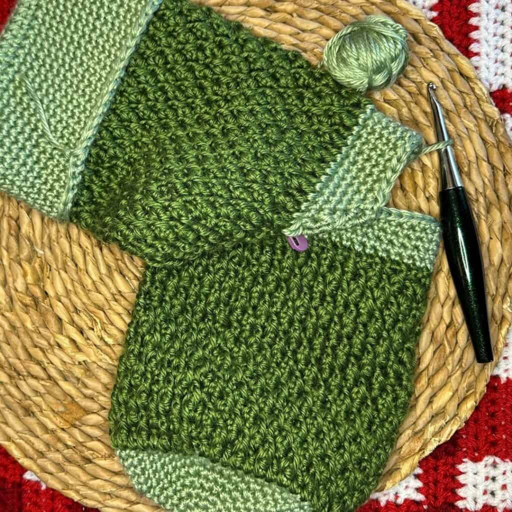 Crochet Christmas stocking with green yarn, perfect for holiday decor.