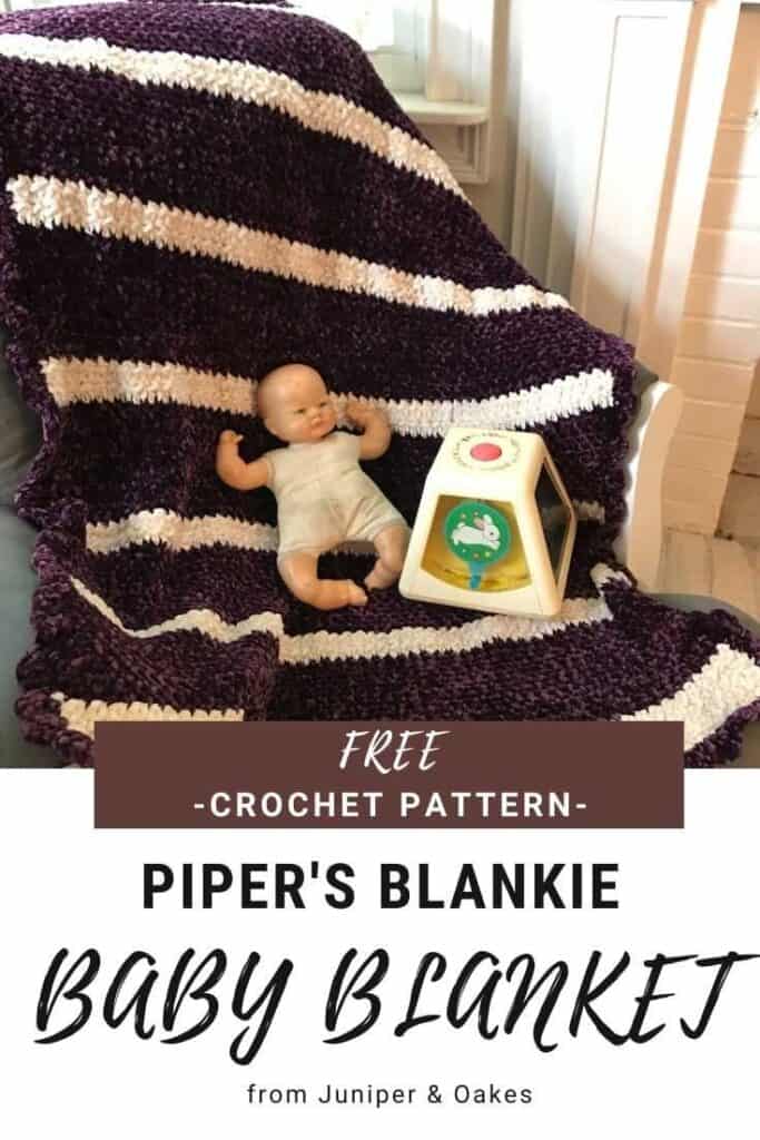 Baby blanket featuring a black and white striped crochet design.