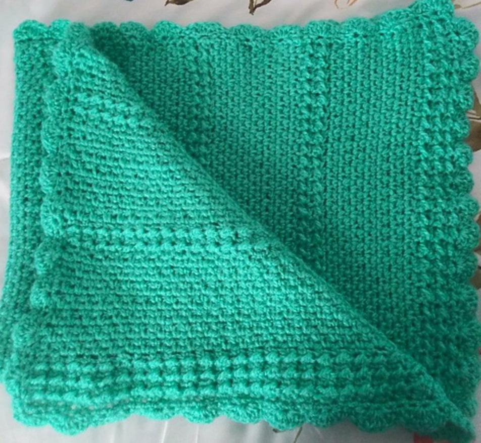Soft green knitted blanket for comfort and warmth.