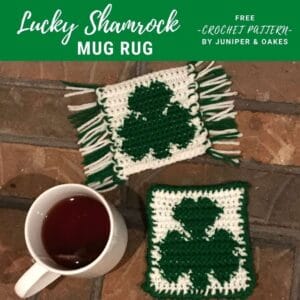 Handcrafted crochet shamrock mug rug with fringe, perfect for St. Patrick's Day.