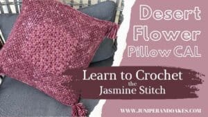 Pillow with pink crochet desert flower design by Juniper and Oakes.