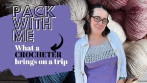 Woman with crochet yarns and supplies for travel, packing for a trip.