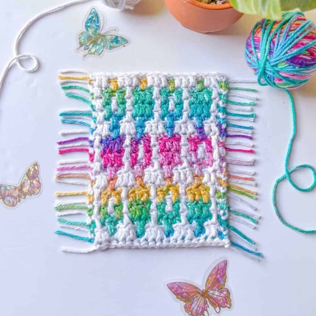 Mosaic crochet blanket square featuring vibrant colors and geometric patterns, perfect for a crochet.