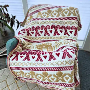 Festive mosaic crochet gingerbread blanket with red and gold patterns.