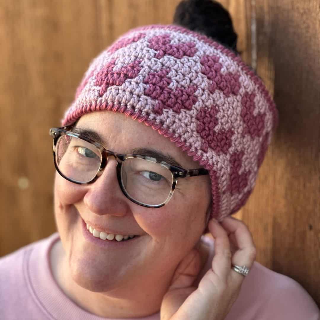 Pink mosaic crochet heart ear warmer, perfect for winter warmth and style. Free pattern available fo.