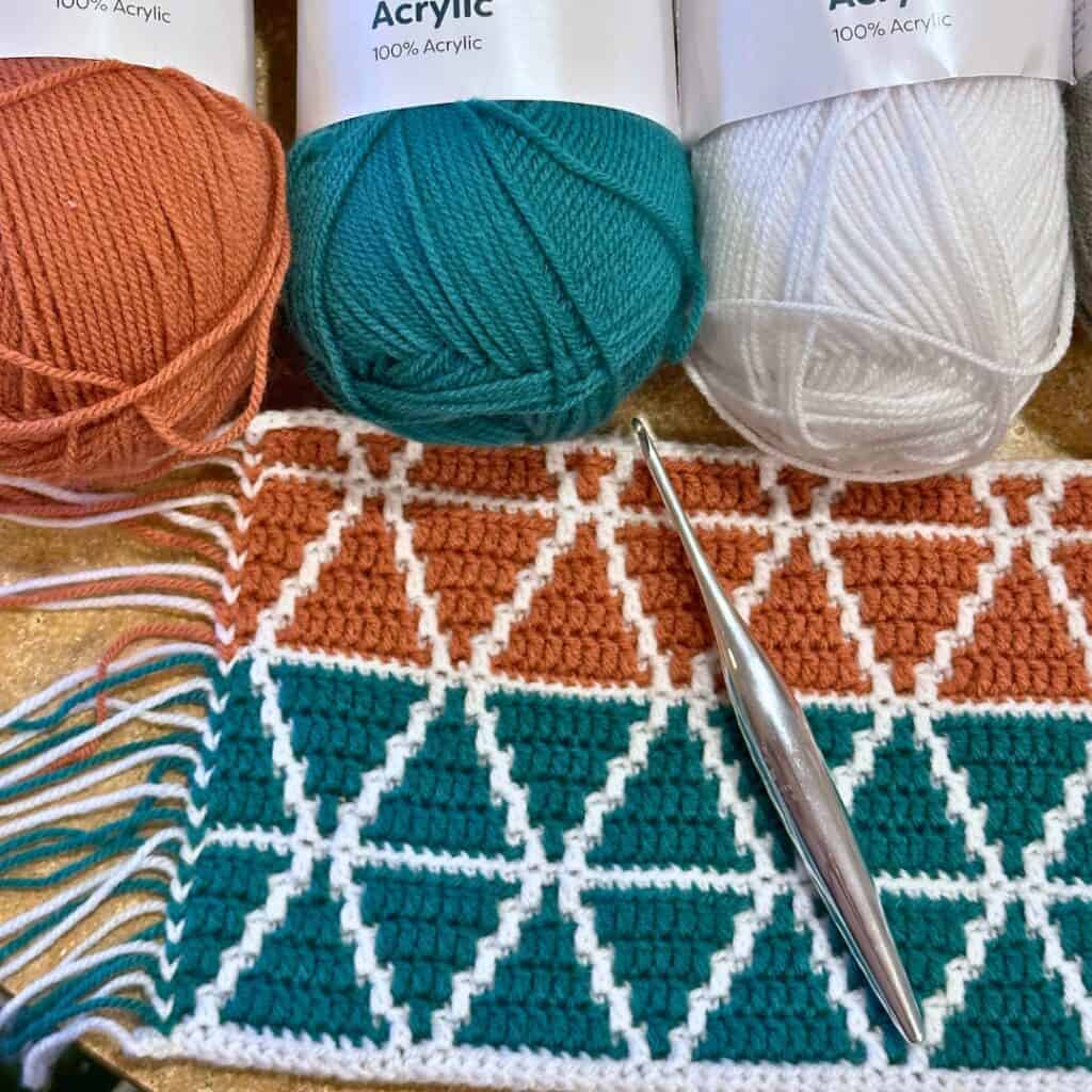 Mosaic Triangles Baby Blanket WIP with hooks and yarn