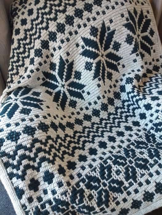 Handcrafted Nordic star mosaic crochet blanket in black and white.