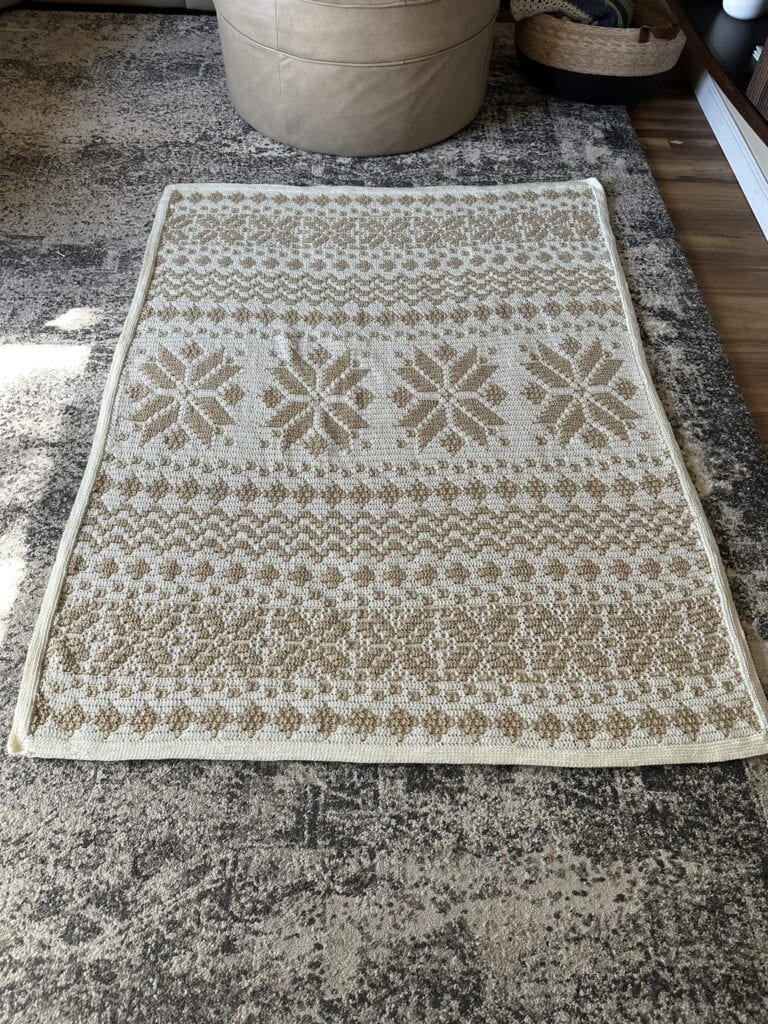 Handcrafted Nordic star mosaic crochet blanket with beige and cream tones.