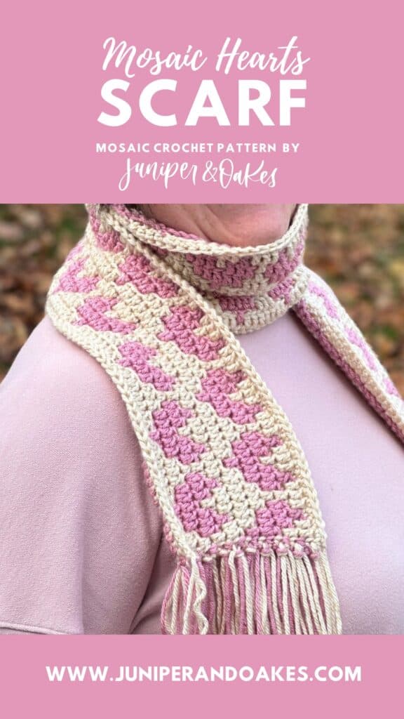 Beautiful handmade mosaic crochet scarf featuring pink and cream heart patterns. Perfect for cozy wi.