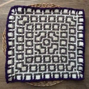 Decorative crochet mosaic square with geometric design, perfect for blankets or wall art.