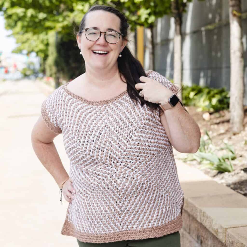 Erin wearing the Mosaic Starburst Tee on a city street, smiling and enjoying the day.