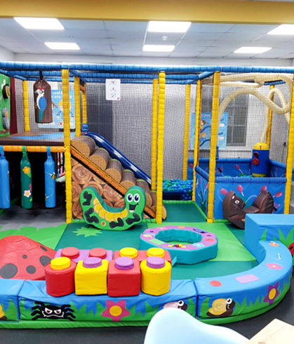 Colorful toddler play area with slide and climbing structures