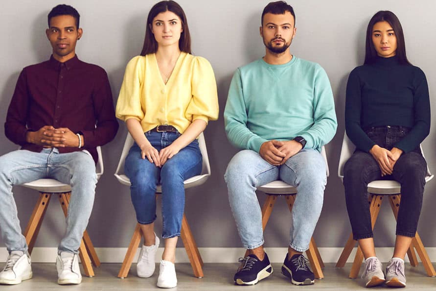 Natural diversity of young adults, sitting in a row against a grey background for medical or psychological research.