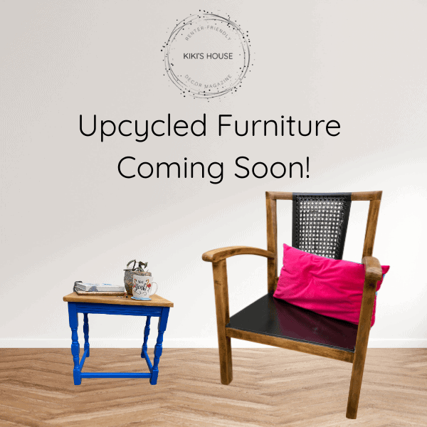 A stylish upcycled chair with a black seat and a pink cushion next to a smaller table painted blue, featuring a coffee cup, against a neutral wall. Text overlay says 'Upcycled Furniture Coming Soon!'