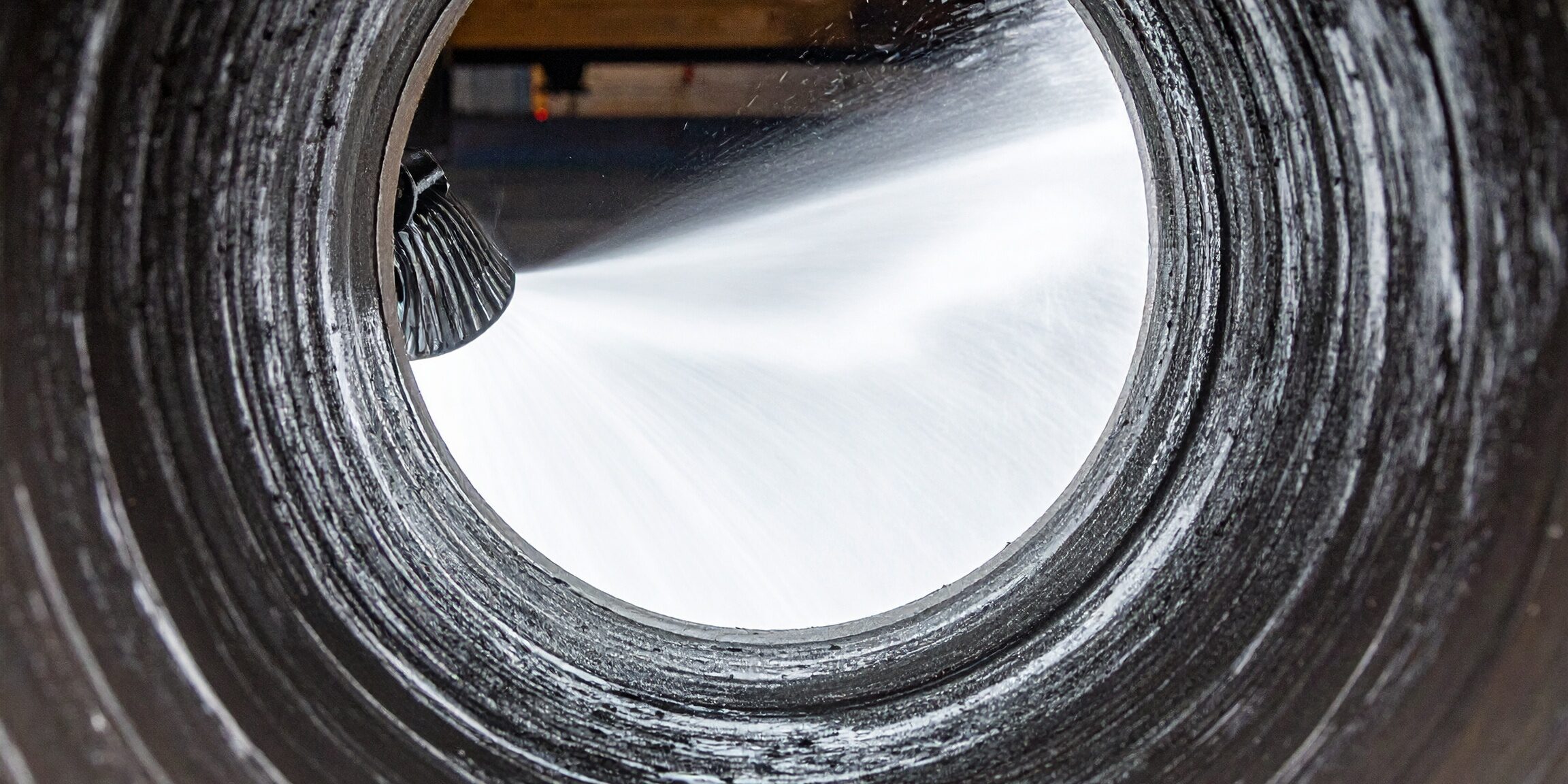 Firefly_Close-up inside a pipe showing hydro jetting water stream clearing grease, sludge, an 136255