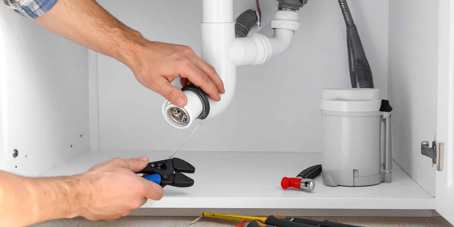 Plumber-Fixing-Under-Sink-Drain-Pipes