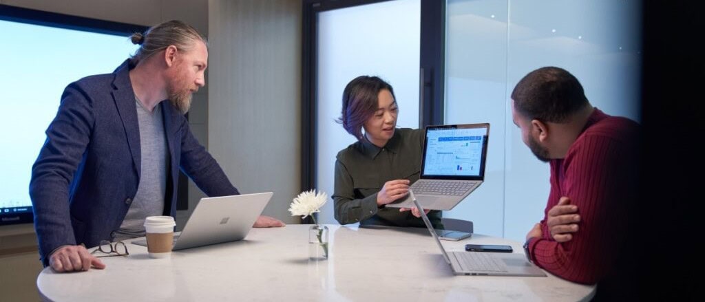 Team discussing cybersecurity solutions at Kirk IT in an office conference room.