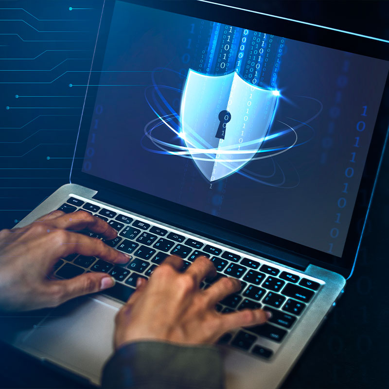 Laptop displaying a digital shield with a lock symbol for cybersecurity protection.