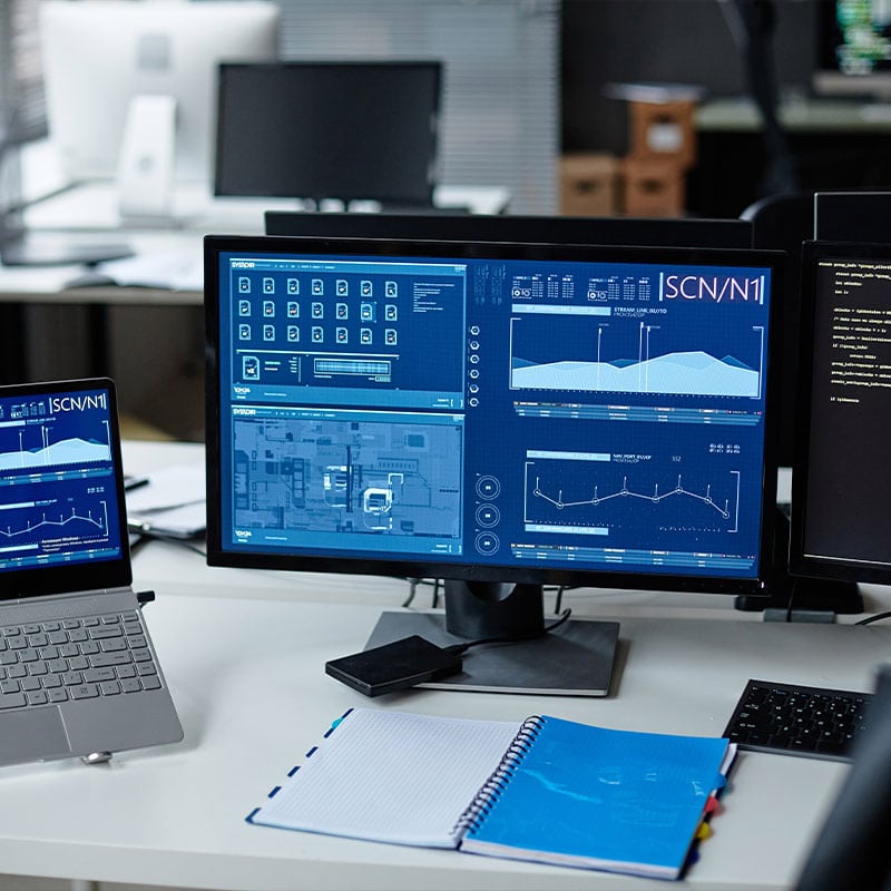 IT network monitoring dashboard with graphs and data on multiple screens.