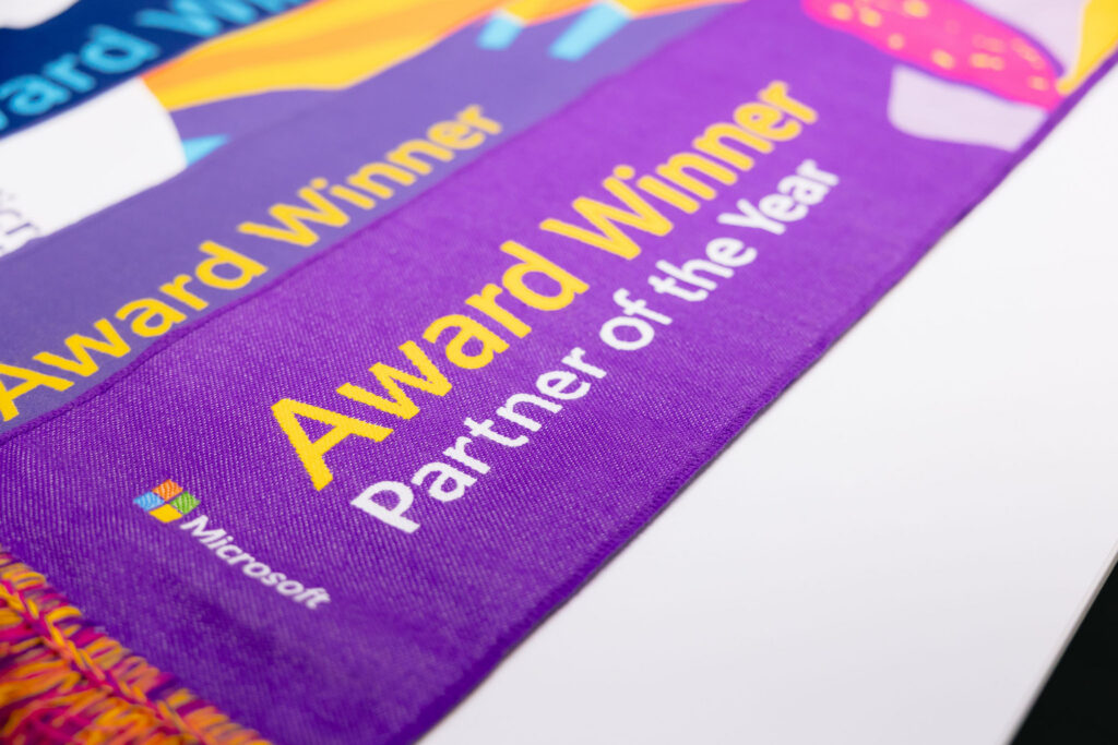 Purple award ribbon with yellow text for Award Winner Partner of the Year.