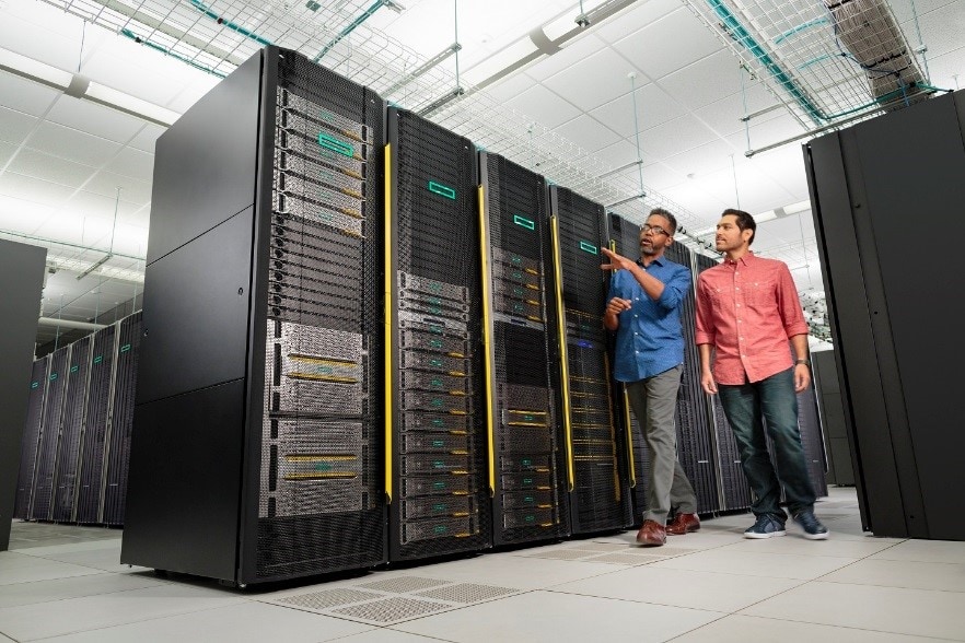 Two IT professionals inspecting server racks in a data center.