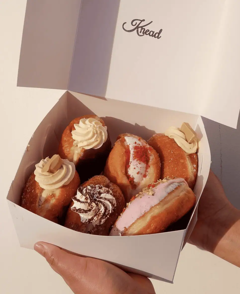 Delicious freshly baked donuts with various toppings, perfect for a treat or dessert.