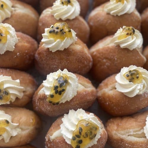 Delicious passionfruit-topped donuts with whipped cream from Knead Donuts in New Zealand.
