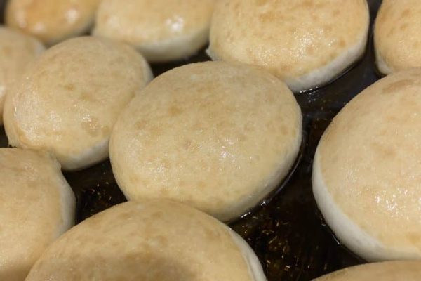 Close-up of golden, soft donuts fresh out of the oven at Knead Donuts.