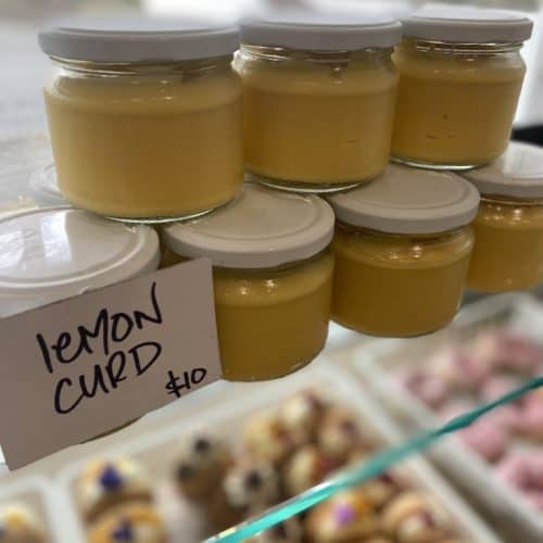 Delicious homemade lemon curd in glass jars, perfect for desserts or spreading.