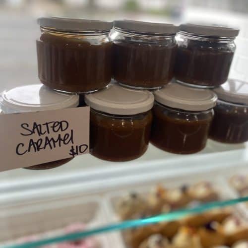 Sweet, glossy donut glaze in glass jars for fresh homemade donuts.