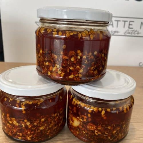 Vibrant spicy chilli chutney in glass jars, perfect for NZ cuisine.
