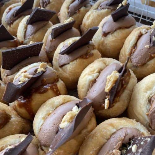 Delectable NZ donuts with chocolate and caramel toppings for the perfect sweet treat.