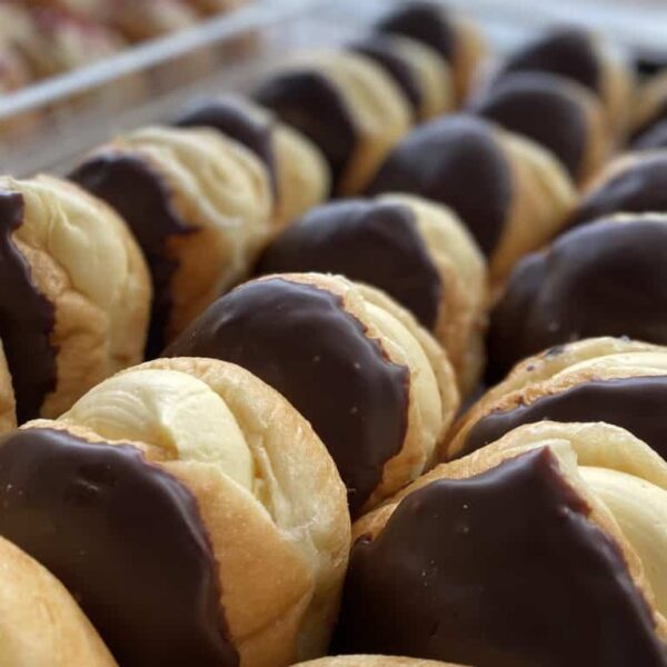 Delicious chocolate-dipped donuts, freshly made at Knead Donuts in New Zealand. Perfect treat for any sweet craving.