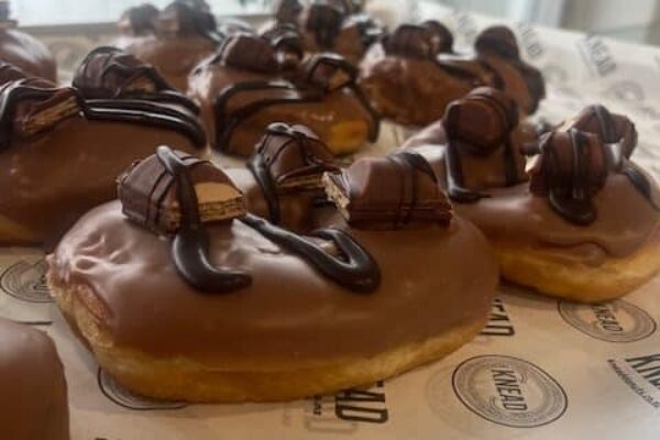 Delicious chocolate-covered doughnuts with rich toppings, freshly made at Knead Donuts in NZ.