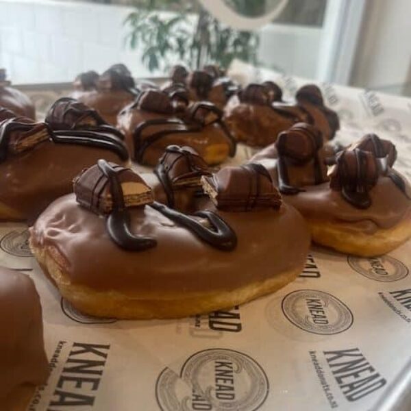 Delicious chocolate-covered doughnuts with rich toppings, freshly made at Knead Donuts in NZ.