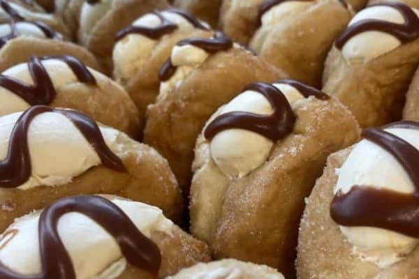 Fresh cream and chocolate drizzled donuts in NZ.