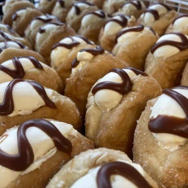 Fresh cream and chocolate drizzled donuts in NZ.