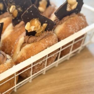 Delicious donuts topped with peanut chunks and chocolate pieces, perfect for peanut slab lovers.