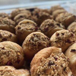 Delicious donuts topped with feijoa and apple crumble, perfect for a sweet treat. Freshly baked with.