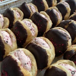 Jelly Tip donuts with pink filling and chocolate coating, perfect for a sweet treat.