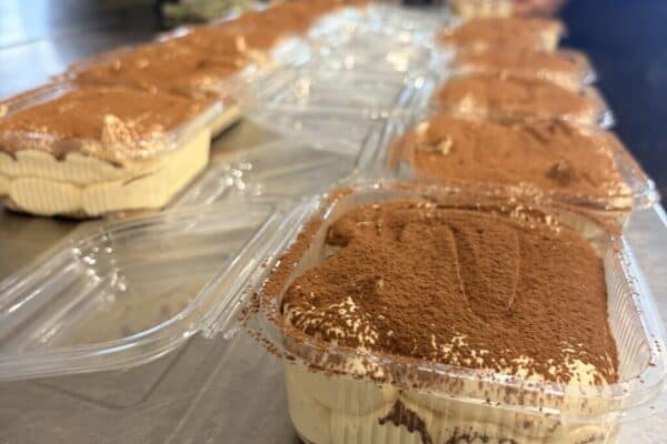 Tiramisu dessert pots with cocoa powder topping from Knead Donuts.
