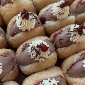 Delicious Black Forest donuts with cream, cherry, and chocolate toppings.