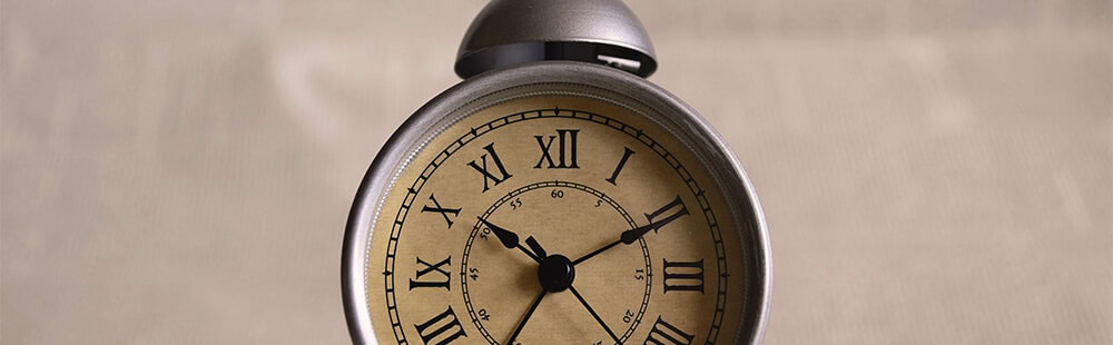 Alarm clock with vintage design on neutral background.