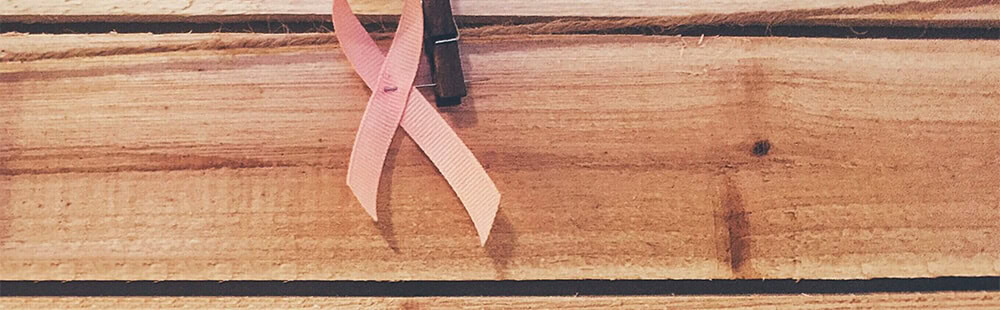 Pink ribbon symbol for breast cancer awareness and support.